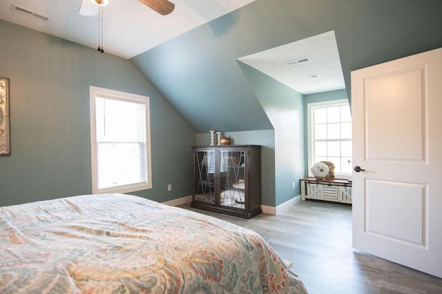 bedroom featuring hardwood / wood-style flooring, vaulted ceiling, and ceiling fan