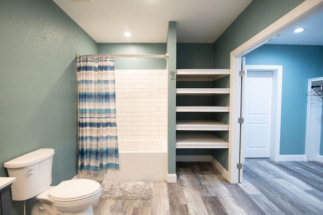 bathroom with hardwood / wood-style flooring, shower / bath combination with curtain, and toilet