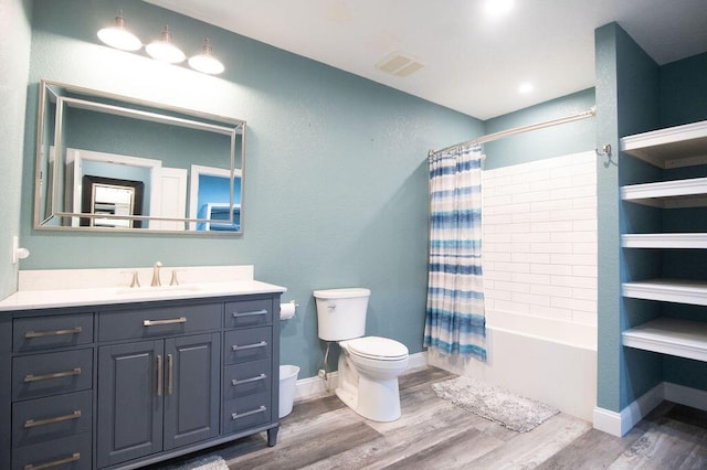 full bathroom with vanity, wood-type flooring, shower / tub combo, and toilet