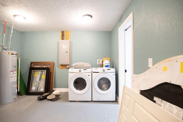 washroom featuring electric panel, electric water heater, washer and dryer, and a textured ceiling