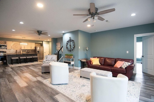 living room with ceiling fan and hardwood / wood-style flooring