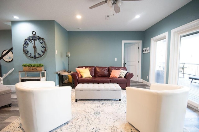 living room featuring ceiling fan and wood-type flooring