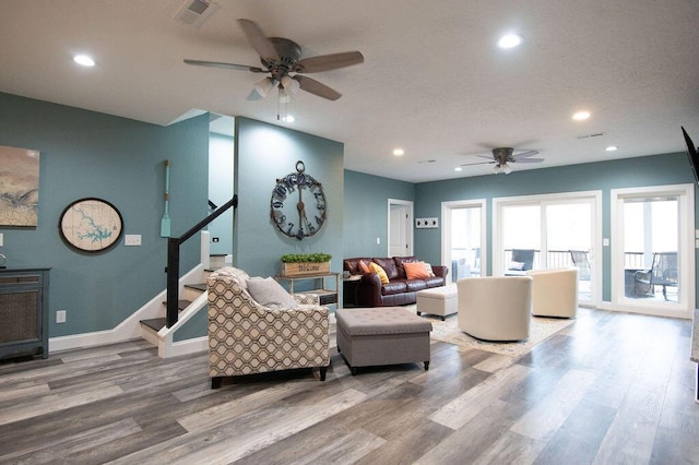 living room with hardwood / wood-style floors and ceiling fan