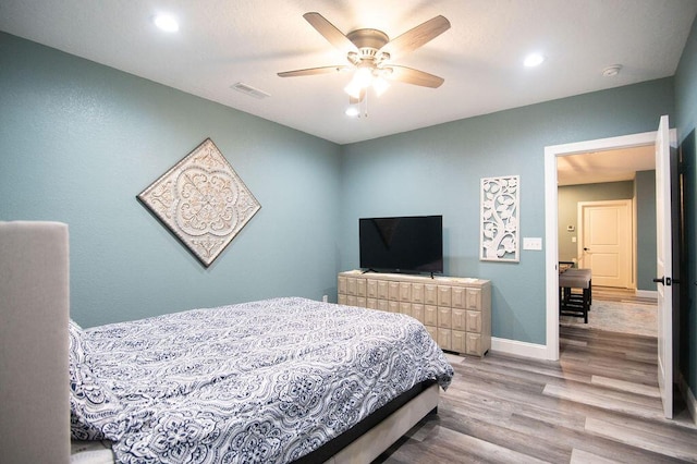 bedroom featuring hardwood / wood-style floors and ceiling fan