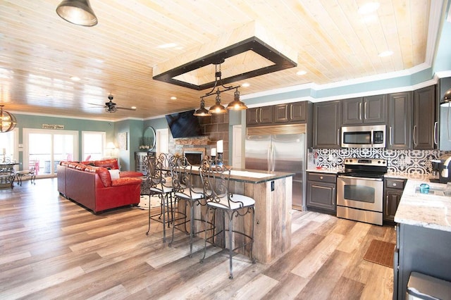 kitchen with decorative backsplash, appliances with stainless steel finishes, ceiling fan, wooden ceiling, and hanging light fixtures