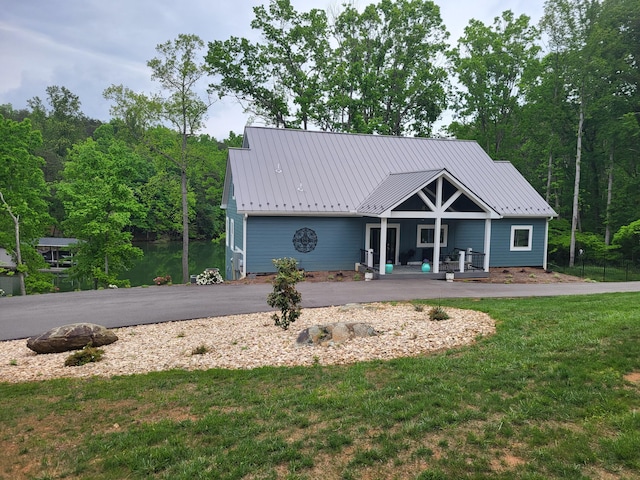 view of front of house with a porch and a front lawn