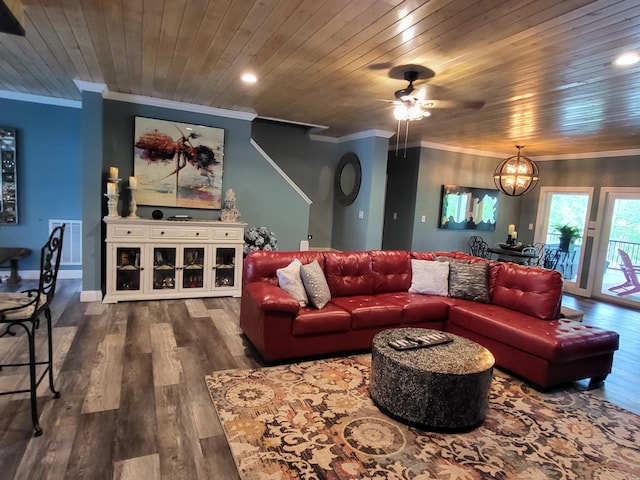 living room with hardwood / wood-style flooring, ceiling fan with notable chandelier, and crown molding