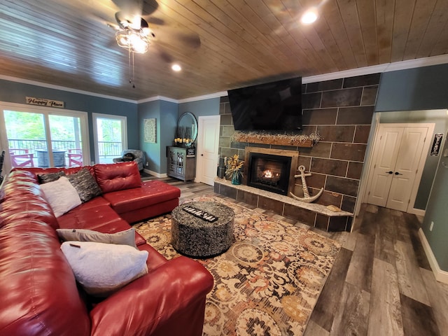 living room featuring a fireplace, hardwood / wood-style flooring, ceiling fan, and ornamental molding