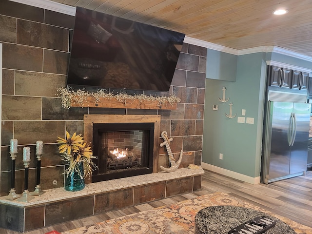 room details with stainless steel refrigerator, a tile fireplace, wooden ceiling, hardwood / wood-style flooring, and ornamental molding