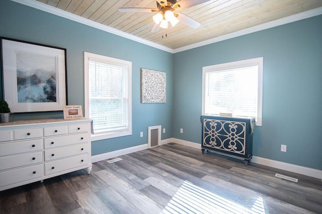 interior space with dark wood-type flooring, ceiling fan, crown molding, and wood ceiling