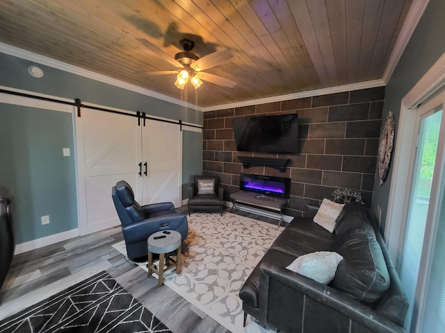 living room with ceiling fan, wooden ceiling, a barn door, crown molding, and wood-type flooring