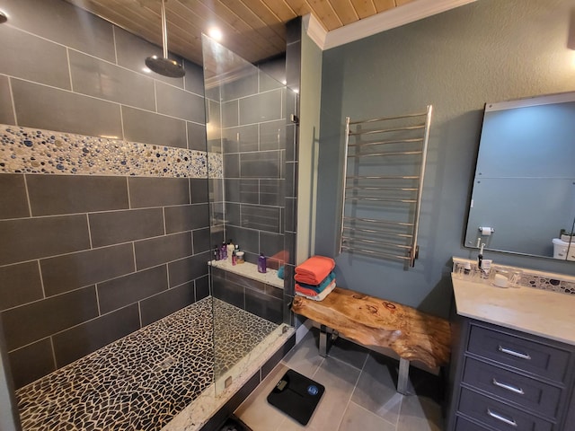 bathroom with tile patterned floors, vanity, crown molding, tiled shower, and radiator heating unit