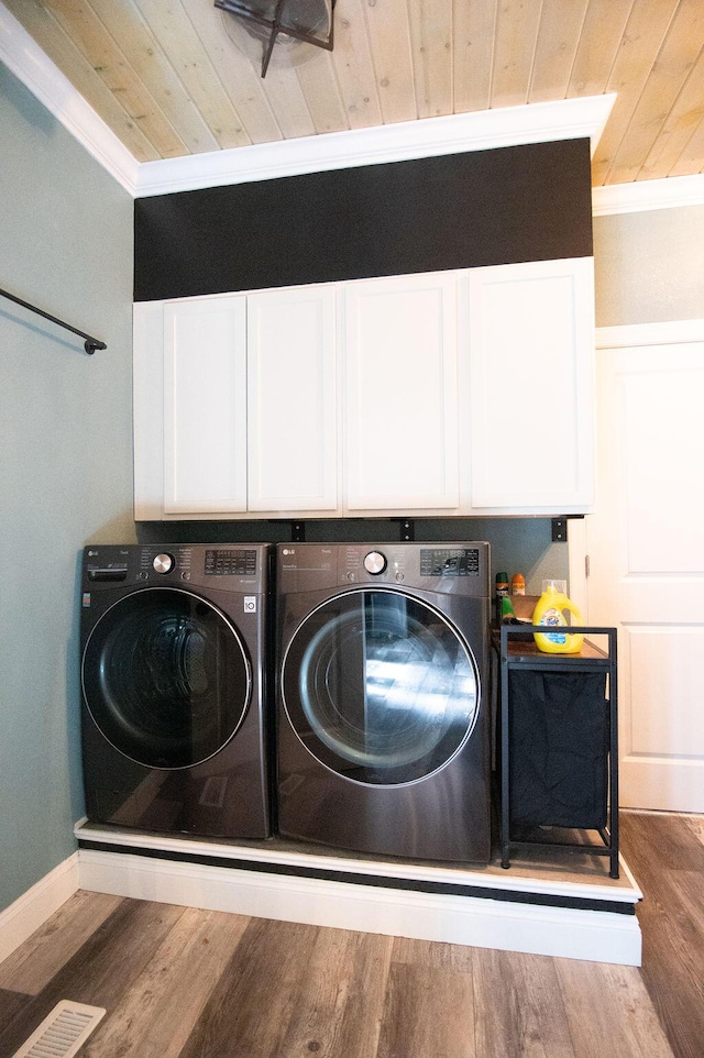 laundry room with cabinets, separate washer and dryer, crown molding, hardwood / wood-style floors, and wood ceiling