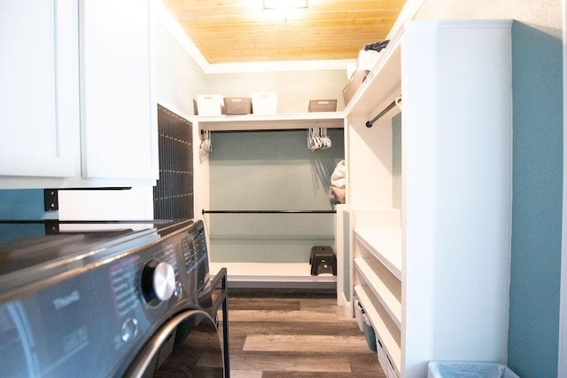 clothes washing area featuring crown molding, dark hardwood / wood-style flooring, wood ceiling, and washer / dryer