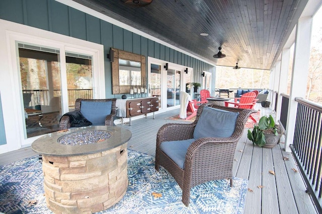 deck featuring an outdoor fire pit and ceiling fan