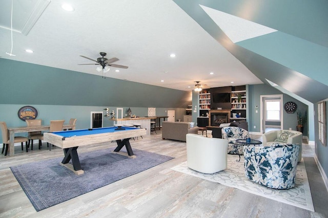 recreation room featuring vaulted ceiling, ceiling fan, built in features, billiards, and light hardwood / wood-style floors