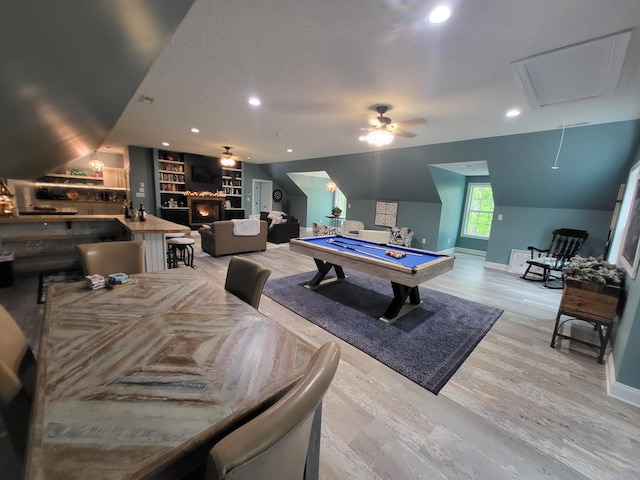 game room featuring vaulted ceiling, indoor bar, light hardwood / wood-style flooring, built in features, and pool table