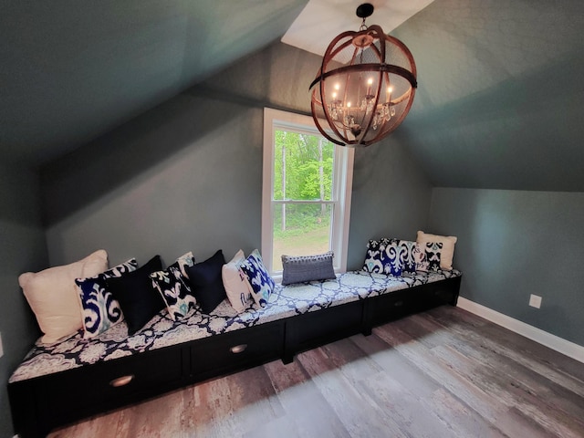 unfurnished bedroom with wood-type flooring, lofted ceiling, and a notable chandelier