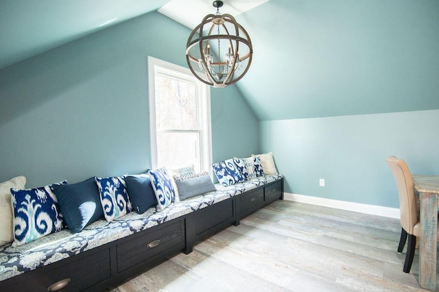 interior space featuring a chandelier, light hardwood / wood-style floors, and lofted ceiling