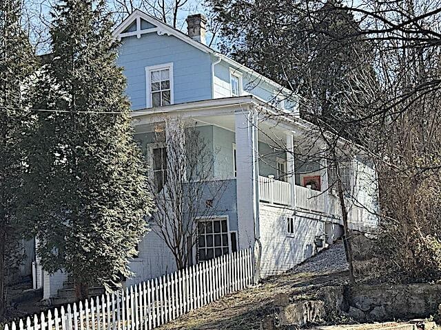 view of side of property with a balcony