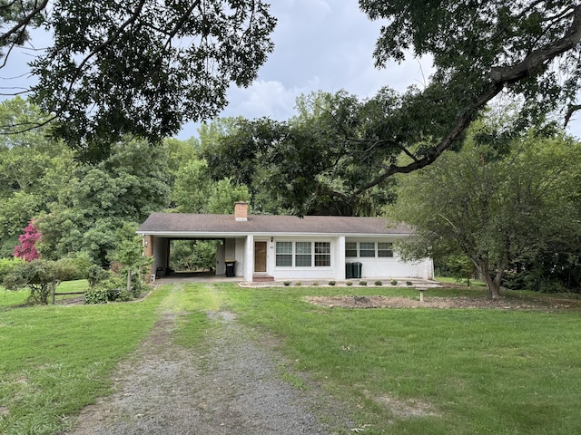 single story home with a front lawn and a carport