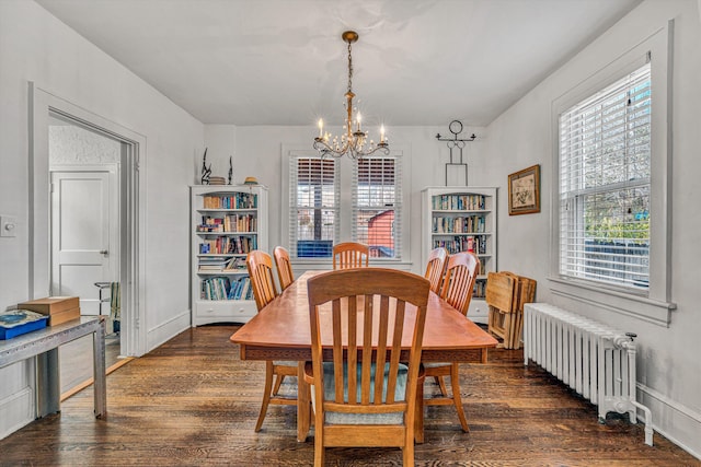 dining room with radiator heating unit, dark hardwood / wood-style flooring, and a notable chandelier