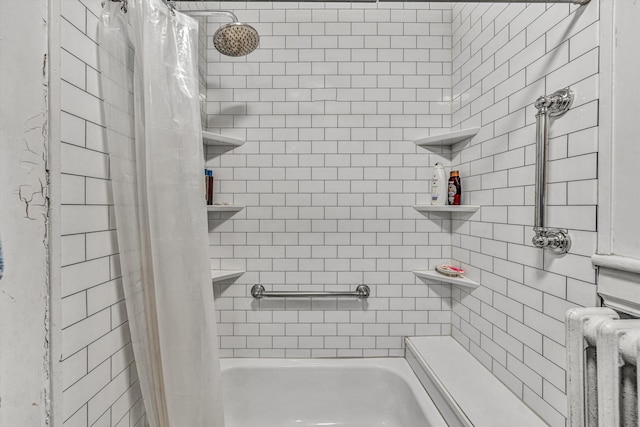 bathroom featuring shower / tub combo and radiator