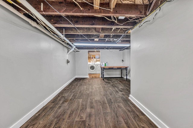 basement with washer and dryer and hardwood / wood-style floors