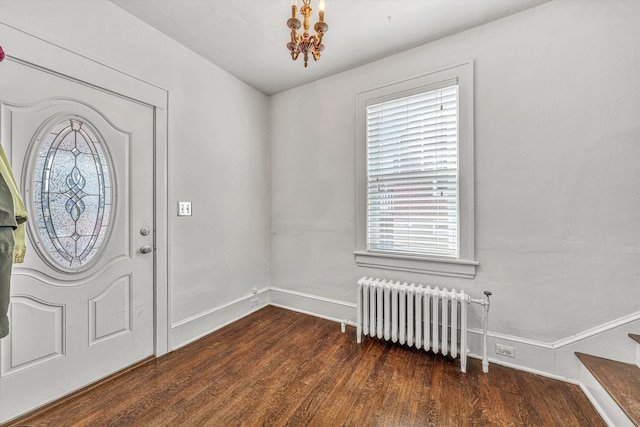 entryway featuring an inviting chandelier, radiator heating unit, and dark hardwood / wood-style flooring