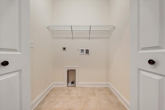 washroom with electric dryer hookup, light tile patterned floors, and washer hookup