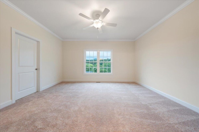 empty room with light colored carpet, ceiling fan, and ornamental molding