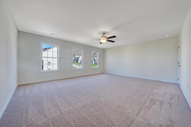 carpeted spare room with ceiling fan