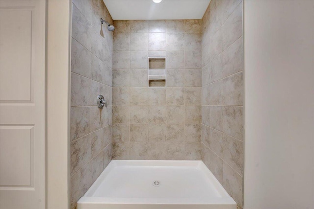 bathroom with a tile shower