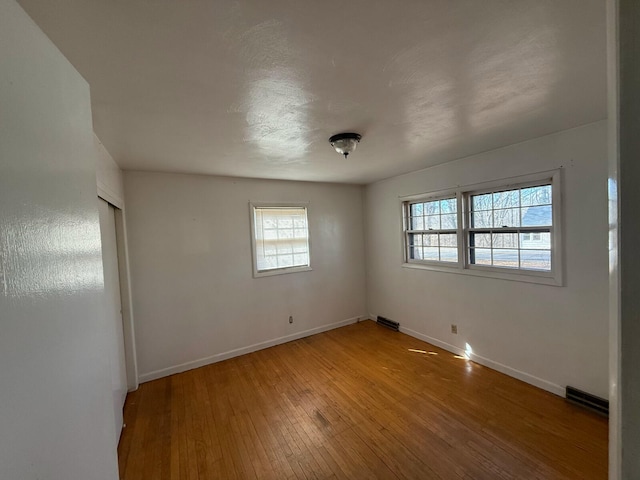 empty room with hardwood / wood-style floors