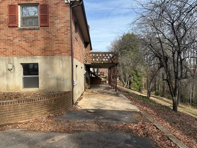 view of side of home featuring a carport