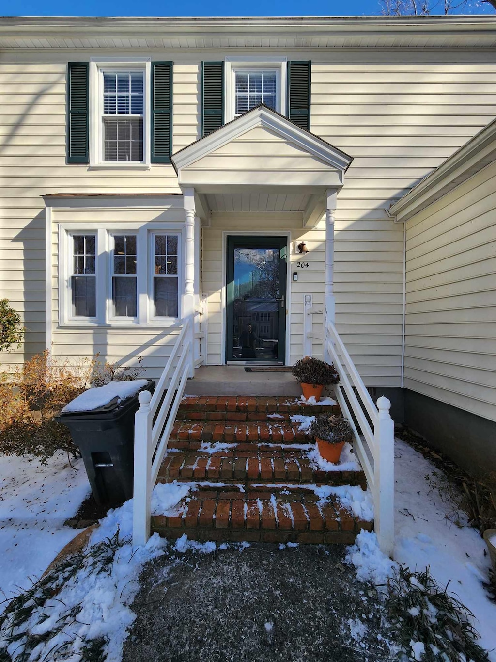 view of snow covered property entrance