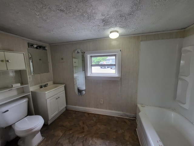 bathroom with vanity, toilet, and a textured ceiling