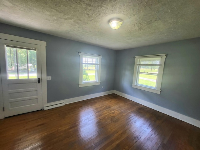 entrance foyer with a textured ceiling, a baseboard radiator, and dark wood-type flooring