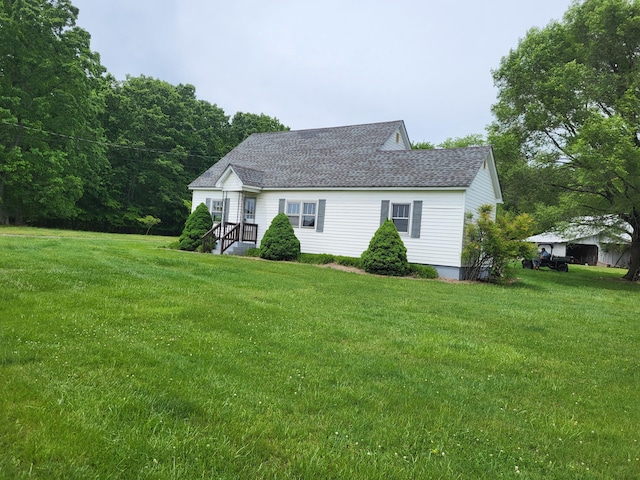 back of house with a lawn