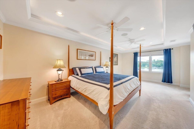 bedroom featuring ceiling fan, crown molding, light carpet, and a raised ceiling