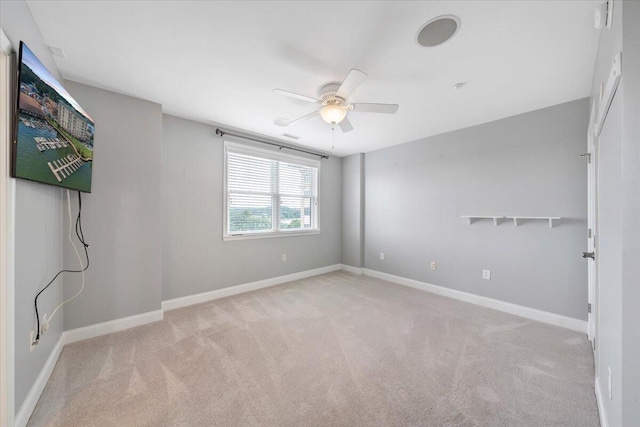 spare room featuring ceiling fan and light colored carpet