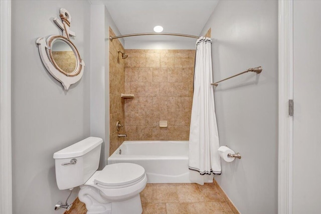 bathroom with toilet and shower / bath combo with shower curtain