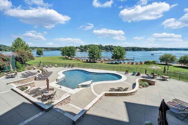 view of pool featuring a patio and a water view