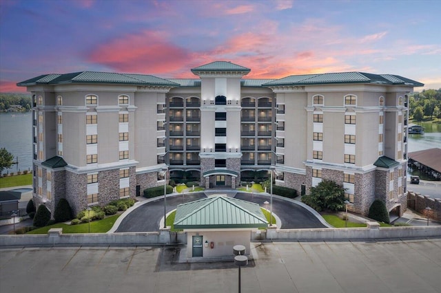 outdoor building at dusk featuring a water view