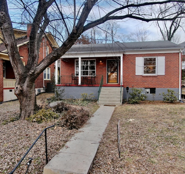 view of front of property featuring a porch and cooling unit