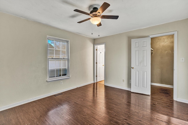 interior space with ceiling fan and dark hardwood / wood-style flooring