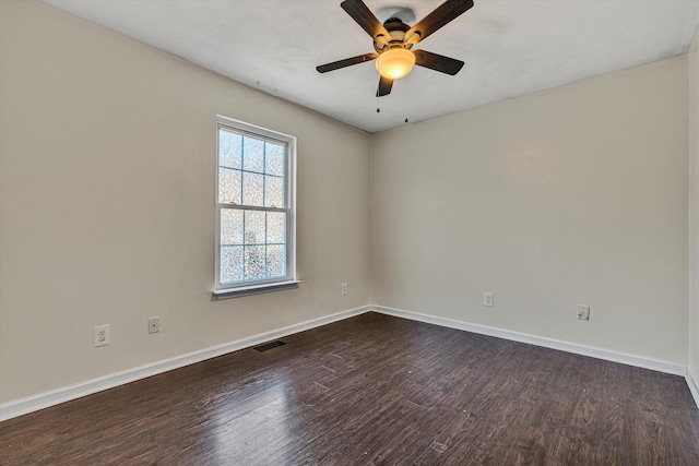 spare room with ceiling fan and dark hardwood / wood-style floors