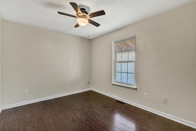 spare room featuring ceiling fan and dark hardwood / wood-style flooring