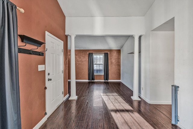 entryway featuring decorative columns and dark hardwood / wood-style floors