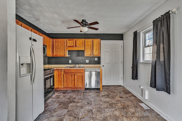 kitchen featuring ceiling fan, appliances with stainless steel finishes, and sink